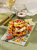 Crispy corn waffles with tomatoes, red onions and yoghurt