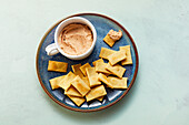 Spelt crackers with tomato and cream cheese dip