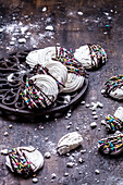 Meringue biscuits with chocolate and coloured sugar sprinkles