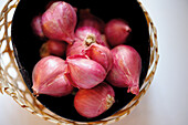 A basket of red Thai onions