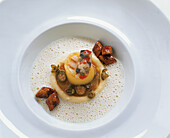 Grilled scallop in a potato coating with caper escabèche and olive quenelles