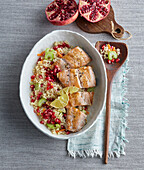 Baked salmon with couscous and pomegranate seeds