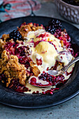 Apple and blackberry crumble with vanilla ice cream