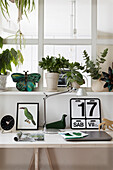 Desk with calendar, above window sill with houseplants