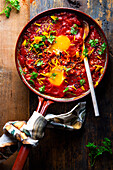 Shakshuka with parsley in a pan