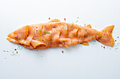 Smoked salmon arranged in the shape of a fish