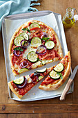 Pizza with zucchini and tomatoes