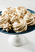 Caramel meringues on a cake stand