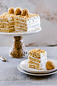Honey vanilla cake, layers of sponge and cream, covered with a vanilla frosting.