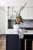 Shaker-style cupboards and an oversized island bench topped with honed dolomite stone