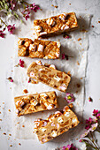Five slices of white chocolate rocky road on wax paper