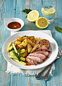Honey duck breast with lemon, served with zucchini and potatoes