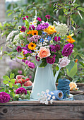 Colorful summer bouquet with roses, sweet william, marigolds, knautia, Queen Anne's Lace, mallow, borage, daisy fleabane, and coneflower