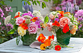 Sommersträuße mit essbaren Blüten: Rosen, Kapuzinerkresse, Phlox, Giersch und wilde Möhre, Ringelblumenblüten liegen