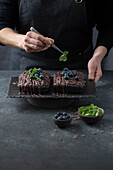 Brownie cake with blueberries and mint leaves