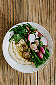 Hummus-Bowl mit grünem Spargel und Radieschen