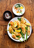 Deep-fried stuffed courgette flowers with a yoghurt dip