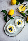 Lemon Curd spooned in meringue nests with blueberries