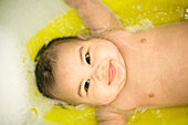 Baby being washed in a bath