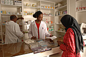 Pharmacist collecting prescription drugs