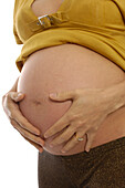 8 month pregnant woman holding her stomach