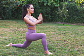 Woman doing yoga in garden at home