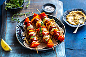 Grilled scallop chorizo skewers with hummus