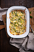 Potato and courgette gratin with cashew cream and vegan cheese substitute