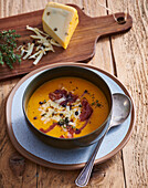 Pumpkin cream soup with cheese and dried ham