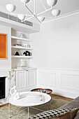 Coffee table and custom-made shelves in the living room with white walls