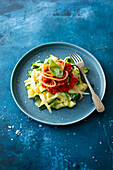 Vegetable noodles with tomato relish and fried onions