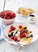 Waffles with raspberries and chocolate glaze