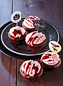 'Brain' cupcakes with berry cream and berry sauce for Halloween
