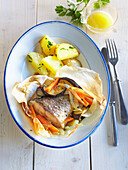 Carp with vegetables baked in papilot