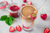 Iced Flat White with strawberry milk and strawberry sauce served in a glass