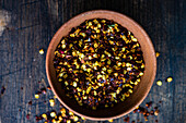 Organic pepper spice on rustic background