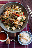 Soy noodles with shrimps and vegetables, prepared in Asian style