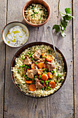 Pork with carrots and peas on couscous