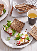 Wholemeal bread with boiled eggs and radishes