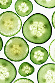 Thin slices of cucumber on a white surface