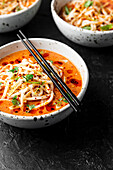 Spicy udon noodle soup in large ceramic bowls