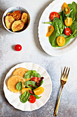 Breaded scamorza with spinach and cherry tomatoes