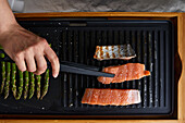 Fresh salmon and asparagus being grilled