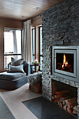 Fireplace in stone chimney breast in elegant living room