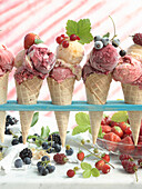 Five ice cream cones with berry ice cream