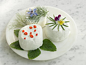 Three kinds of fresh goat cheese with fresh herbs