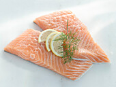 Two slices of salmon with lemon and dill