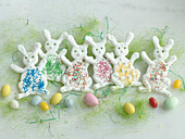 Meringue Easter bunnies with sugar sprinkles and candy eggs