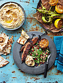 Hummus, grilled paprika and lemon, salad with parsley, pomegranate, minced meat skewers