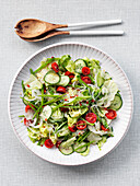 Salad with cucumber, tomatoes, onion, suger snaps and asian dressing